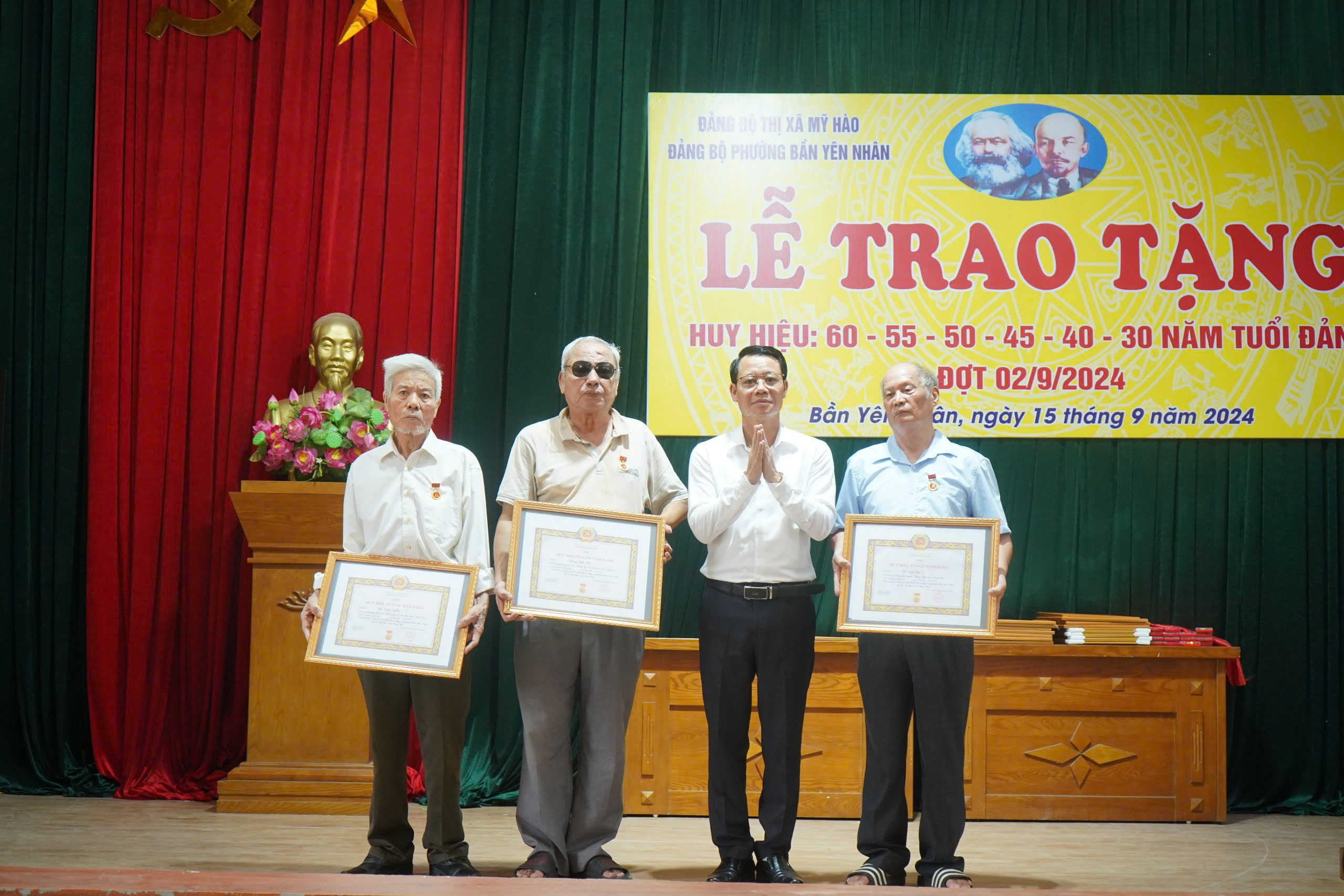 Đồng chí Đào Quang Minh, Phó Bí thư Thường trực Thị ủy, Chủ tịch HĐND thị xã trao Huy hiệu Đảng cho các đảng viên lão thành